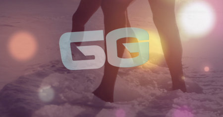 Standing couple wearing swimwear in shallow water on shore at sunset, with 5G overlay, lens flares. Romance, tranquility, sunset, beach, leisure, outdoor, natureの写真素材