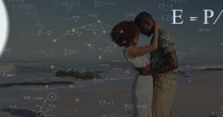 Embracing couple in summer clothing standing on sandy beach, with math and molecular overlays. Romance, affection, connection, digital overlay, conceptual, serenity, harmonyの写真素材