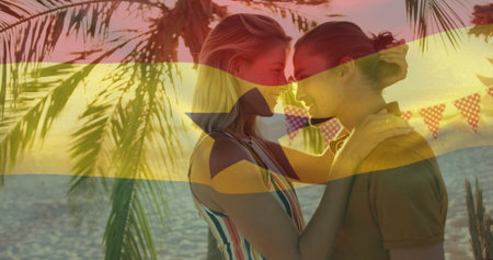 Couple embracing in striped top on sandy beach at sunset, with palm trees, pennant banners, horizon....