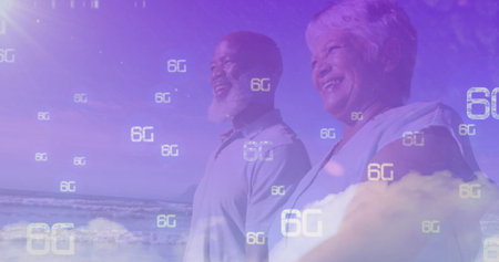 Standing mature couple gazing toward horizon on sandy beach, with floating 6G digital symbols....