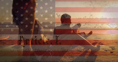 Relaxing couple in swimwear on sandy shore at sunset, with surfboard American flag script overlay....