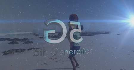 Piggybacking couple in swimwear walking along beach, with lens flare, 5th Generation logo overlay....