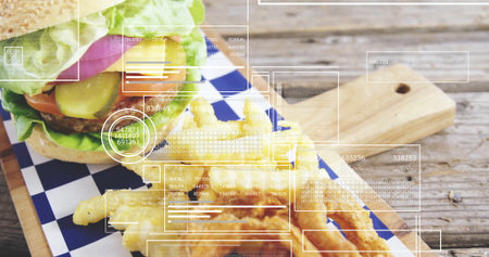 Displaying lettuce-topped burger with fries on checkered wax paper on tabletop, with data overlays....