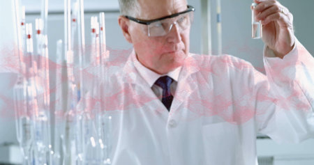 Scientist wearing lab coat and goggles examining test tube in laboratory, with metal test tube rack. Scientist, laboratory, research, science, innovation, experimentation, sterileの写真素材