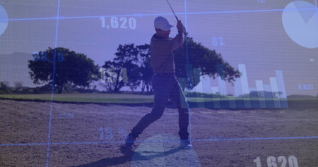 Golfer swinging golf club wearing golf cap, shirt in sandy bunker on fairway, with chart overlay. Athletic, precision, technology, outdoor, landscape, competitive, strategicの写真素材