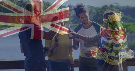 Friends clinking beers on deck by water, with Union Flag and Cayman coat of arms overlays. Recreation, camaraderie, leisure, nature, celebration, rustic, tranquilityの写真素材