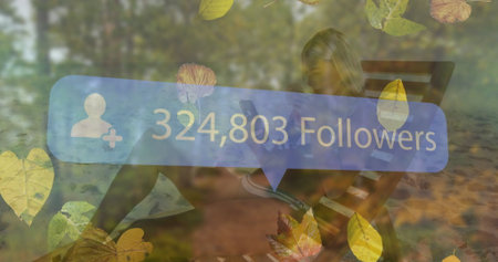 Checking smartphone woman in athletic wear on park bench among leaves, displaying 324,803 followers. Nature, relaxation, digital, outdoor, vibrant, leisure, lifestyleの写真素材