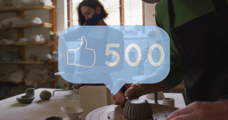Artisan wearing apron shaping bowl on pottery wheel in workshop, with 500 like overlay, copy space....