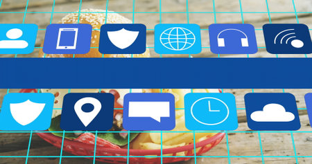 Displaying red wire basket holding burger and fries on wooden tabletop with cyan grid, blue icons....