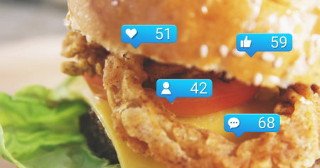 Showing chicken sandwich with sesame bun, cheese, tomato in kitchen, blue notification icons. Sandwich, fast food, appetizer, comfort food, gourmet, rustic, crave-worthyの写真素材