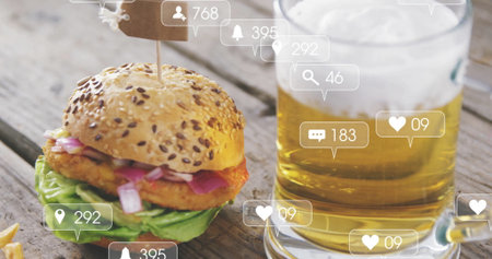 Displaying seeded slider burger and glass beer mug on rustic patio table, with social media icons. Gourmet, casual, rustic, appetite, refreshment, celebration, hospitalityの写真素材