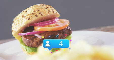 Burger featuring sesame seed bun, beef patty and vegetables in kitchen, with digital overlay icon....