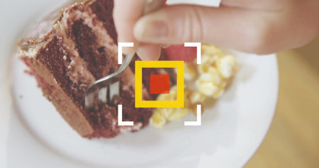 Cutting chocolate cake slice with fork on tabletop with scrambled eggs and focus reticle. Dessert, culinary, gourmet, rustic, indulgence, hospitality, food presentationの写真素材