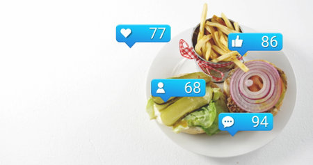 Displaying open-faced burger and fries on white table, with social icons, copy space. Food, snack, casual, modern, advertising, vibrant, gourmetの写真素材