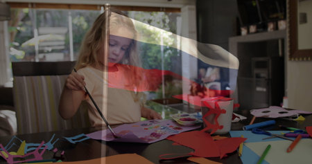 Painting preschool girl using brush on paper at dining table, with palette and markers. Crafts, childhood, creativity, vibrant, artistic, education, leisureの写真素材