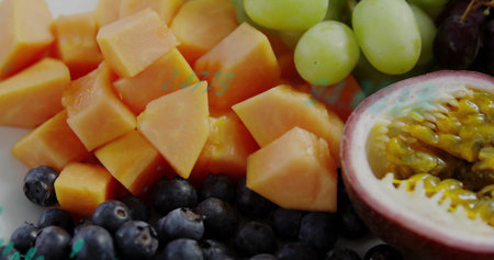 Displaying fruit on kitchen counter, featuring papaya cubes, passionfruit, blueberries and grapes. Freshness, vibrant, healthy, natural, colorful, organic, produceの写真素材