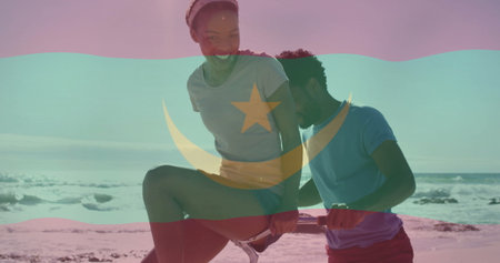 Balancing woman in sportswear with man steadying horizontal fitness bar on beach, with flag overlay. Outdoor fitness, beach workout, active lifestyle, athleticism, teamwork, wellness, summerの写真素材