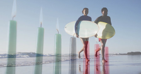 Walking couple in wetsuits carrying white and yellow surfboards at beach shoreline, with calm waves. Beach, athletic, minimalist, outdoor, adventure, water sport, motionの写真素材