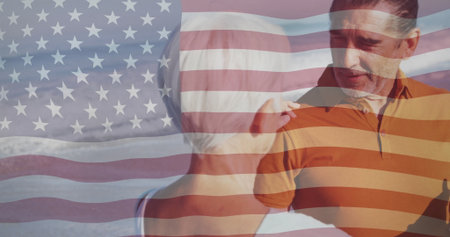 Mother touching adult son shoulder while son holding dark bottle on sandy beach, with flag overlay. Family, celebration, patriotism, relaxation, warmth, outdoor, picturesqueの写真素材