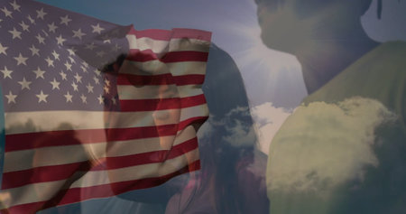 Gazing five adults tilting heads toward sun under open sky, with translucent American flag overlay....