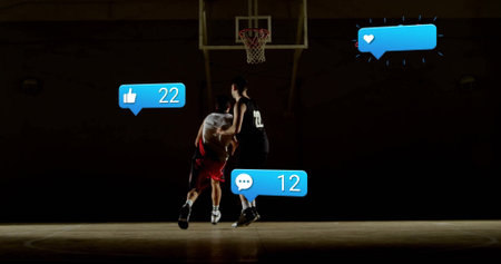 Dribbling basketball toward hoop, white dribbler facing defender on court with social media icons. Athletics, competition, sport, teamwork, intensity, modern, vibrantの写真素材