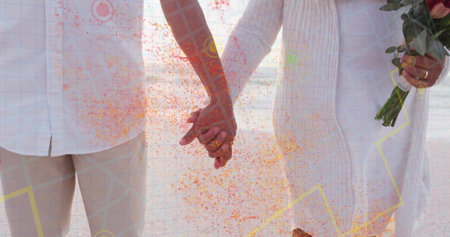 Holding hands senior couple wearing white linen in studio, with pink tulip bouquet, confetti, grid. Celebration, unity, togetherness, maturity, elegance, minimalism, positivityの写真素材