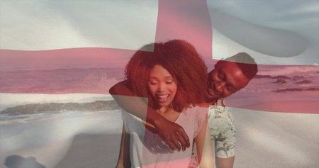 Smiling romantic couple embracing sandy beach edge, with semi-transparent red cross overlay. Romance, affection, serenity, connection, landscape, tranquility, lifestyleの写真素材