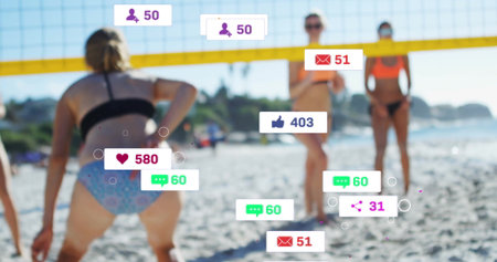 Playing sports bikini-clad women hitting volleyball on beach under yellow net with media overlays. Athletics, wellness, outdoor, leisure, fitness, teamwork, vibrantの写真素材