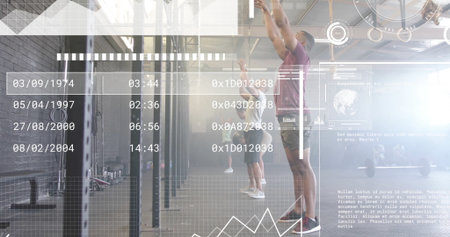 Reaching upward, man in burgundy shirt grasping pull-up bar in gym, with weight plates, barbells. Strength training, fitness, workout, athletic, gymnasium, performance, exerciseの写真素材