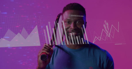 Holding tennis racket on shoulder man in blue sports shirt showing bar-chart line-graph in studio. Athlete, performance, digital, visualization, branding, modern, energeticの写真素材