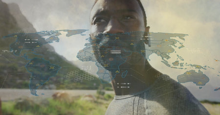 Standing man wearing shirt viewing map overlay on coastal hillside, with earbud and data nodes....