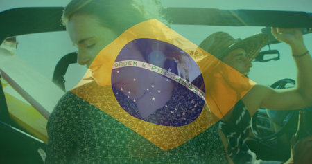 Turning passenger and gripping driver in convertible sports car on road with Brazil flag overlay. Adventure, travel, vibrant, lifestyle, transportation, tourism, leisureの写真素材