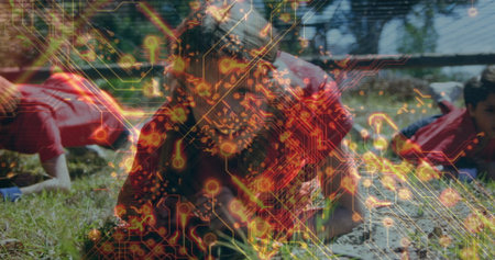 Crawling children wearing red sportswear under low net barrier on mud field, circuit board overlay....