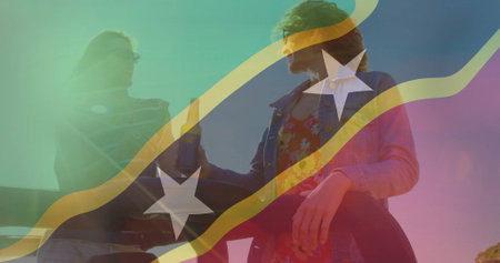 Friends in denim and floral attire clinking beer bottles on rooftop railing at sunset with overlay. Celebration, camaraderie, leisure, outdoor, vibrant, lifestyle, festiveの写真素材