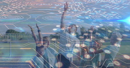 Stretching coach and children in sportswear raising arms on sports field, with soccer goalpost. Athletics, youth, teamwork, outdoor, fitness, activity, energyの写真素材