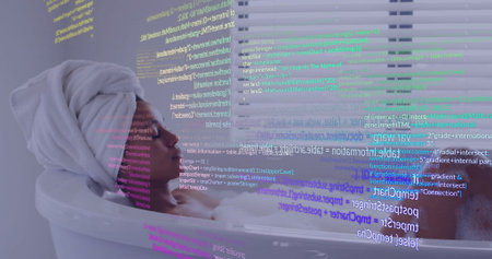 Reclining woman with towel turban displaying vivid code streams across face, in white bathtub. Technology, wellness, relaxation, digital art, modern, comfort, innovationの写真素材