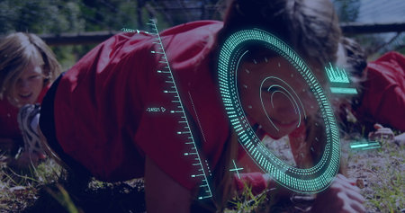 Crawling kids in red-and-black sportswear under rope net on grassy field, with teal HUD overlay. Adventure, teamwork, outdoor activity, youth, vibrant, exploration, youthful energyの写真素材