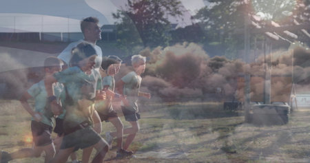 Running coach leading six children wearing gear across field under pavilion seating, equipment box. Athletics, teamwork, outdoor, fitness, youth, activity, competitionの写真素材