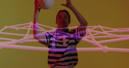Reaching upward adult woman holding white ball overhead in studio, with pink wireframe network. Futuristic, digital, technology, motion, abstract, vibrant, geometricの写真素材