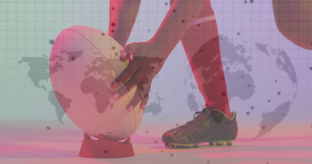 Aligning athlete wearing red socks, cleats positioning ball on tee in studio, map projection. Athlete, sportswear, motion, competitive, fitness, dynamic, modernの写真素材