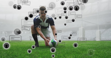Positioning player in jersey kneeling, placing rugby ball on tee near goalposts with chat bubbles. Athletic, stadium, digital, sport, outdoor, competitive, modernの写真素材