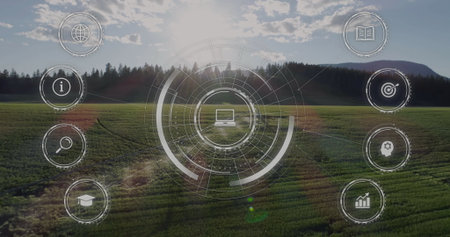 Displaying circular interface overlapping agricultural field, with laptop icon and learning symbols. Futuristic, technology, innovation, education, data, sustainability, landscapeの写真素材