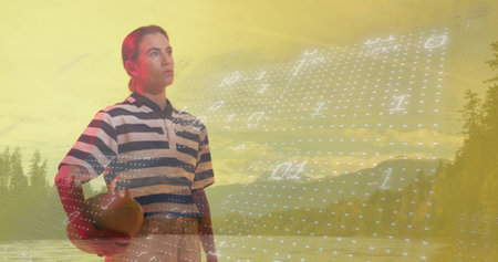 Standing woman in striped polo shirt holding brown leather ball at lakeshore with binary overlay. Nature, landscape, tranquility, digital, technology, outdoor, recreationの写真素材