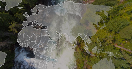 Flowing waterfall cutting through woodland at mountain path, with orange kayak, world map overlay....