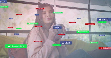 Cradling white mug, mid adult woman relaxing on sofa in home lounge, with floating UI icons. Cozy, relaxation, solitude, modern, home, mindfulness, comfortの写真素材