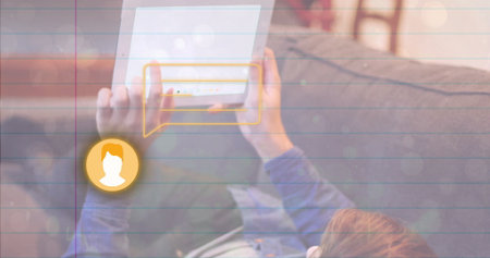 Reclining man tapping white tablet in home living room, with chat bubble and avatar icon graphic....