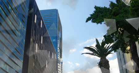 Rising glass-clad skyscrapers in downtown, palm tree, leafy tree, clouds, reflections, copy space. Cityscape, architecture, modern, professional, urban, minimalist, corporateの写真素材