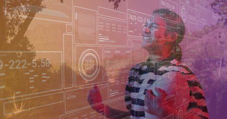 Standing woman wearing VR headset and striped top in park, interacting with HUD data, copy space. Futuristic, immersive, technology, digital, outdoor, vibrant, innovationの写真素材