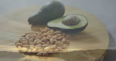 Displaying cutting board with whole avocado, halved avocado, seed, almonds in studio river sunset. Organic produce, wellness, rustic, fresh ingredients, natural, lifestyle, aestheticの写真素材