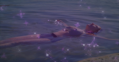 Floating woman wearing two-piece swimsuit drifting on calm lake, with purple geometric overlays. Serenity, relaxation, watercolor, ethereal, leisure, landscape, wellnessの写真素材